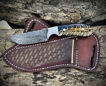 Traditional cowboy hunting knife with blue/white pine cone and pancake leather sheath image 0