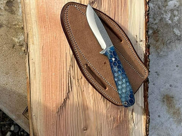 D2 handmade cowboy skinning knife with blue honey comb handle and scout carry leather sheath image 0