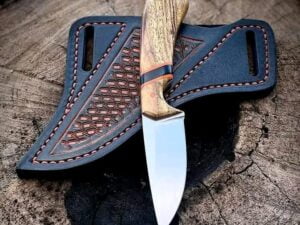 custom cowboy knife with D2 steel blade, olive wood handle, and brown leather sheath