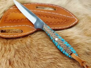 Cowboy rasp knife with forged farrier rasp steel blade, pine cone handle and cowhide leather sheath. Overall length 8 inches.