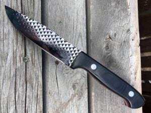 Buffalo horn handle cowboy knife with horizontal sheath.