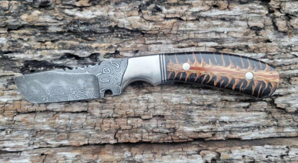Damascus steel Cowboy Knife with hand-forged snub nose blade, pine cone handle, and leather sheath.
