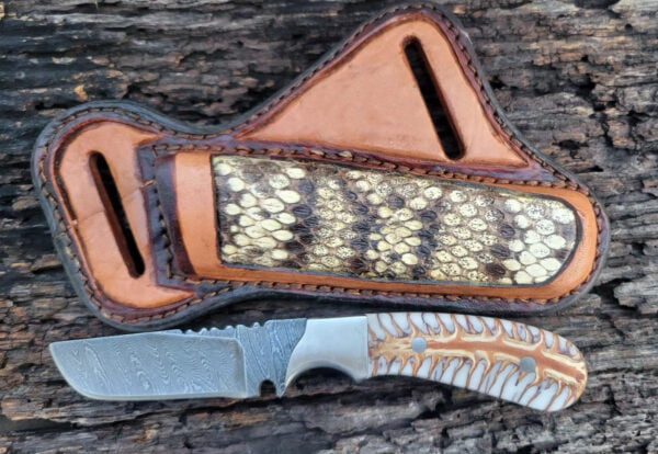 Handmade Damascus Steel Cowboy Knife - Hand-forged, full tang knife with a twisted Damascus steel blade, pine cone handle, and horizontal carry cross draw pancake leather sheath.