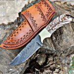 Handmade Damascus Cowboy Knife with Twist Pattern Blade, Pine Cone Handle, and Leather Sheath.