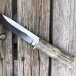 5160 carbon steel cowboy knife with whitetail antler handle and western style leather sheath.