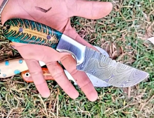 Handmade Damascus Cowboy knife green pine cone handle and pancake leather sheath.