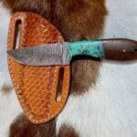 Damascus steel handmade cowboy hunting knife with Turquoise handle and leather sheath.