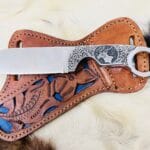 D2 tool steel bull cutter knife with fancy engraving Handmade leather sheath.