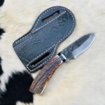 High carbon 1095 Cowboy knife with whitetail antler handle with free cross draw leather sheath.