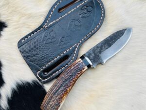 High carbon 1095 Cowboy knife with whitetail antler handle with free cross draw leather sheath.