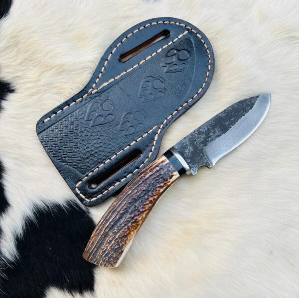 High carbon 1095 Cowboy knife with whitetail antler handle with free cross draw leather sheath.