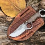 Rasp steel handmade finger hole cowboy knife with walnut wood handle and cross draw leather sheath.