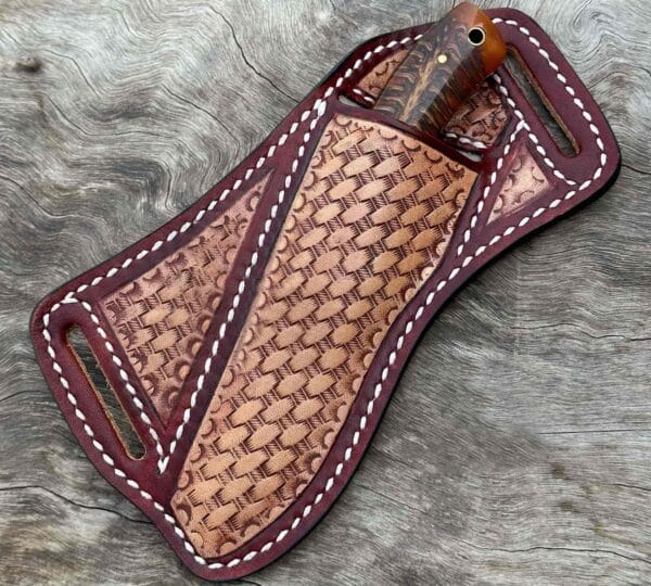 Hand-forged Damascus steel cowboy knife in pancake leather sheath.