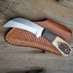 D2 hawksbill knife with Stag antler handle and leather sheath.