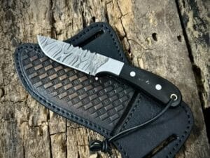 Custom Damascus Cowboy knife with bull horn handle and pancake leather sheath.