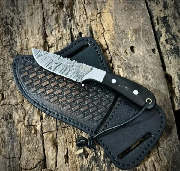 Custom Damascus Cowboy knife with bull horn handle and pancake leather sheath.