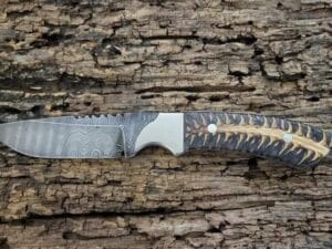 Damascus Cowboy Knife with Sheath, featuring a hand-forged blade, pine cone handle, and genuine leather sheath.