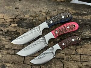 Farrier Rasp Cowboy Knife Set: Three hand-forged knives with full tang construction, pine cone handles, and leather sheaths.