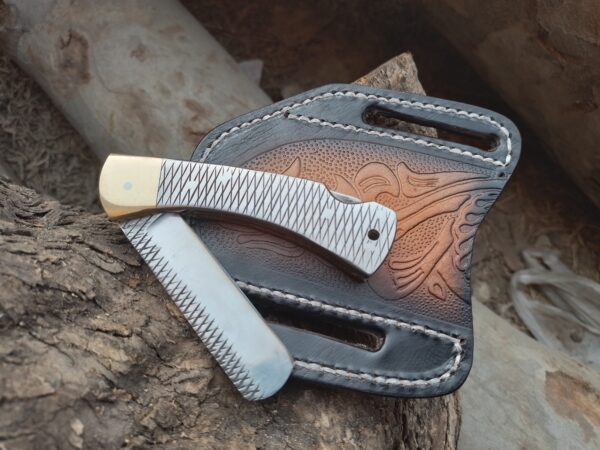 Custom folding bull cutter knife with its genuine leather cross-draw sheath.