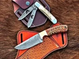 Complete Cowboy Knife and Sheath Set including a Fixed Blade Damascus Cowboy Knife and a Double Blade Custom Trapper Knife, both with their custom leather sheaths.