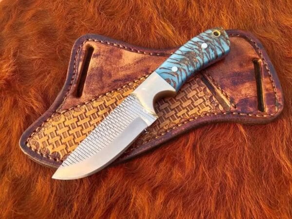 Rasp steel cowboy hunting knife with pancake leather sheath and pine cone handle.