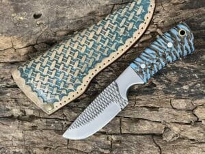 Handcrafted Farrier Rasp Knife by Custom Cowboy Knives with pine cone handle and leather sheath.